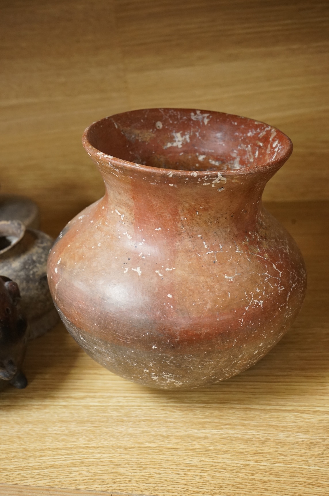 A collection of various South American vessels some in the form of grotesque heads, largest 24cm wide